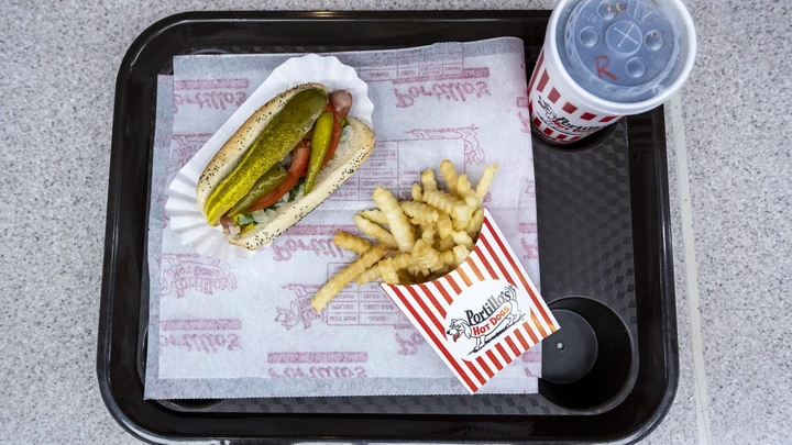 A hot dog, fries and soda arranged at a Portillo’s restaurant in Chicago, Illinois, US, on Tuesday, Sept. 27, 2022. National chains including Del Taco Restaurants Inc., Portillos Inc. and Chipotle Mexican Grill Inc. say its getting easier to find employees, with their staffing at or above pre-Covid levels. Photographer: Christopher Dilts/Bloomberg via Getty Images