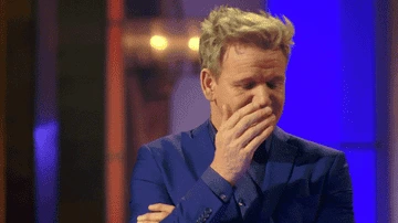Gordon Ramsay covering his face with his hand