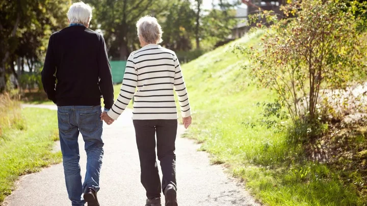 Senior couple strolling on a park path