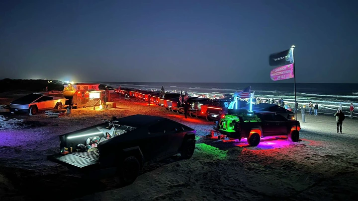 Tesla Cybertrucks gathered at Boca Chica Beach on Saturday for a spectacular light display. 