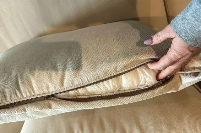 A person unzips the Joybird Wilder Sofa Sectional cushion