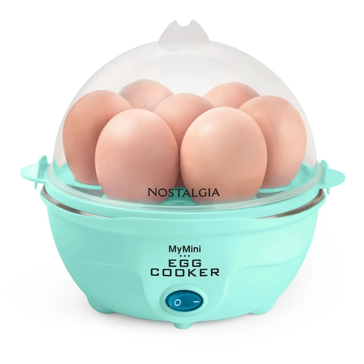 Electric egg cooker with a clear lid, containing several eggs. Labeled &quot;Nostalgia MyMini Egg Cooker.&quot; Featured in a shopping article