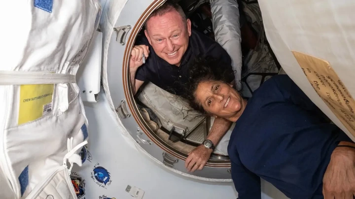  File Photo: This undated handout picture from Nasa released on July2, 2024 shows NASA’s Boeing Crew Flight Test astronauts (from top) Butch Wilmore and Sunita Williams inside the vestibule between the forward port on the International Space Station’s Harmony module and Boeing's Starliner spacecraft.  Photograph: (AFP) 