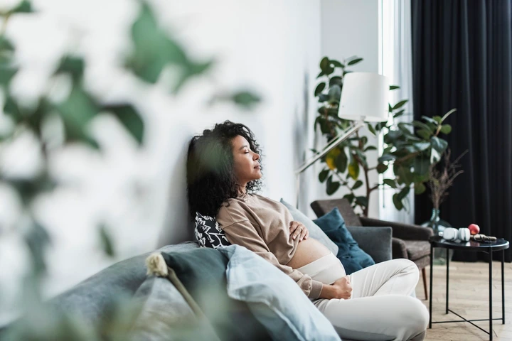 Pregnant woman sitting on a couch
