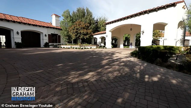 The expansive driveway features garage spaces that can accommodate up to 16 vehicles.