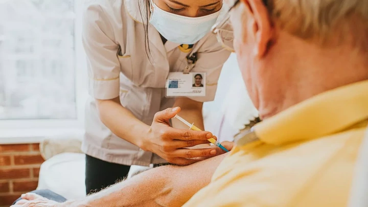Nurse administering a vaccine to a patient