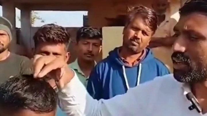Man pulling at another man's hair