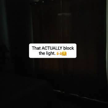 same reviewer's bedroom with the curtains pulled closed. The room is completely dark. 
