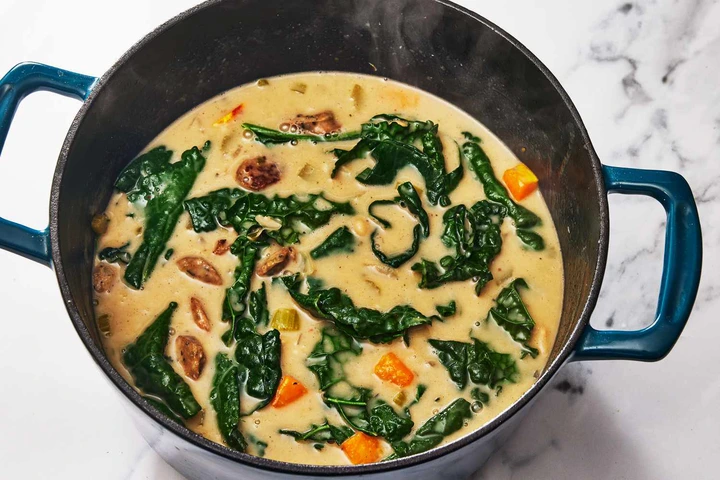 Southern Living Million Dollar Soup adding the kale and roasted vegetables 