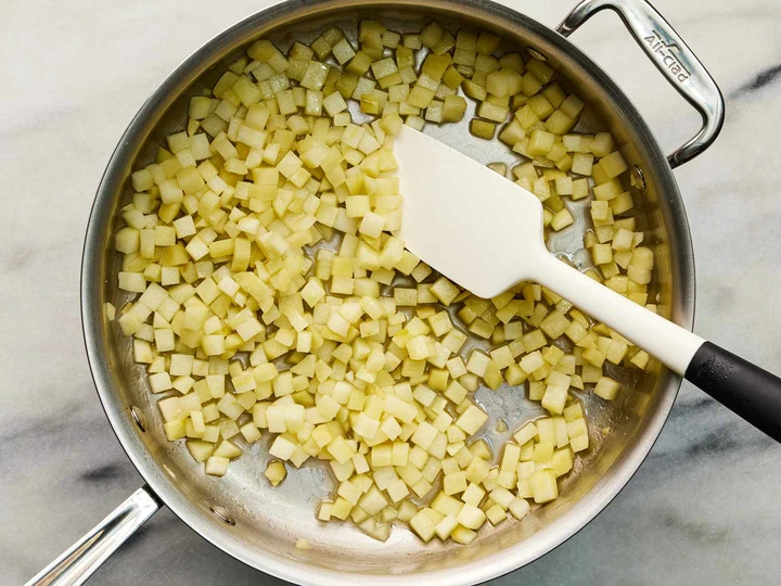 Diced apple and sugar mixture cooking in a skillet 