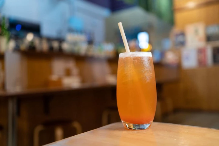 Homemade cold peach tea in glass with blur background
