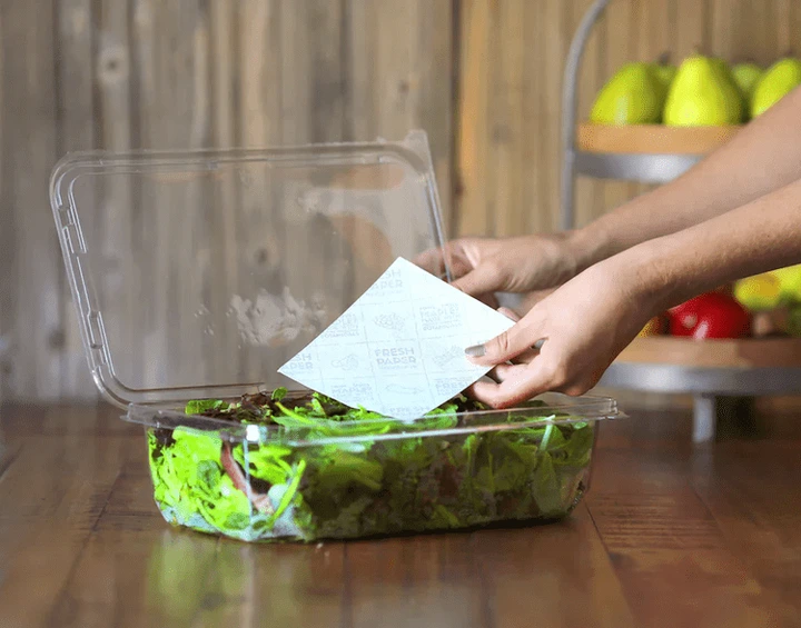 A bag of produce with a fresh paper inserted into it.