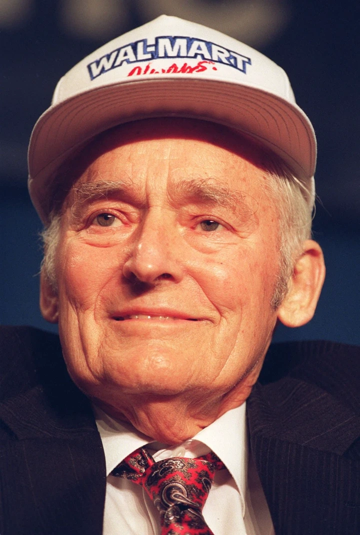An old photo of an older man in a baseball cap that says Walmart