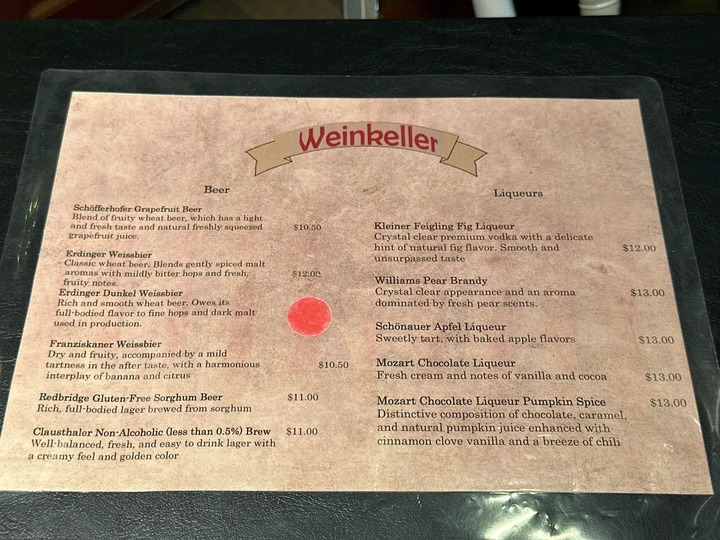 Menu from Weinkeller displaying beer and liqueur options with names, descriptions, and prices.