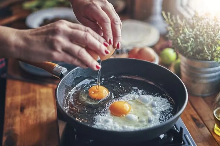 Cooking an Egg in a Frying Pan in a Home Kitchen