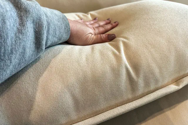 A person presses on the Joybird Wilder Sofa Sectional